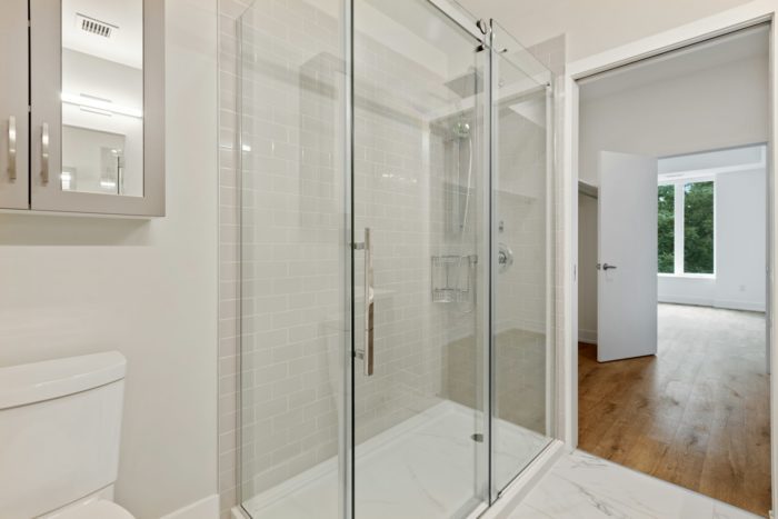 Clear glass door with a white steel frame